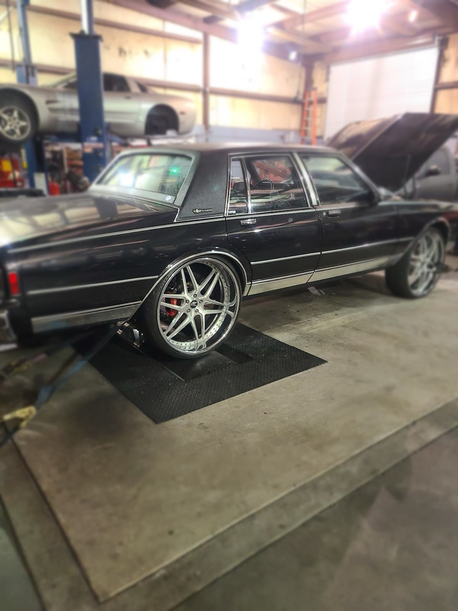 A car on the lift inside the L&W Tire service bay in Stockbridge, GA