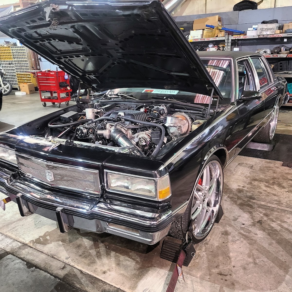 An LS-powered Chevy Caprice with the hood up in the L&W Tire service bay in Stockbridge, GA